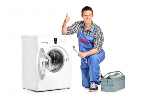 Repairman giving thumb up next to a washing machine